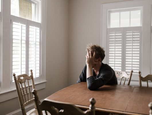 Person leaning on table