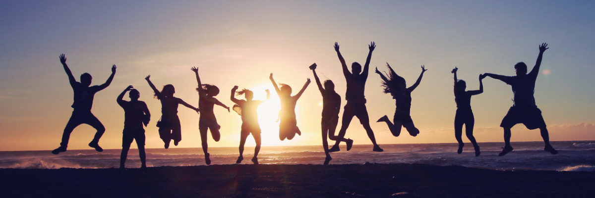 Health and Wellbeing - Photo of people jumping with joy, silhouetted by a sunset in the background