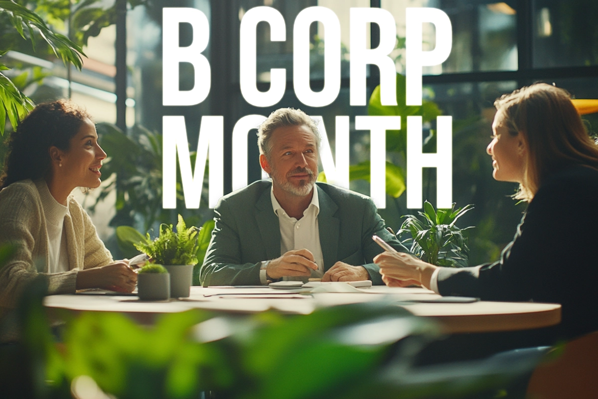 People sitting around a table having a discussion, with "B Corp Month" in the background | B Corp certification guidance